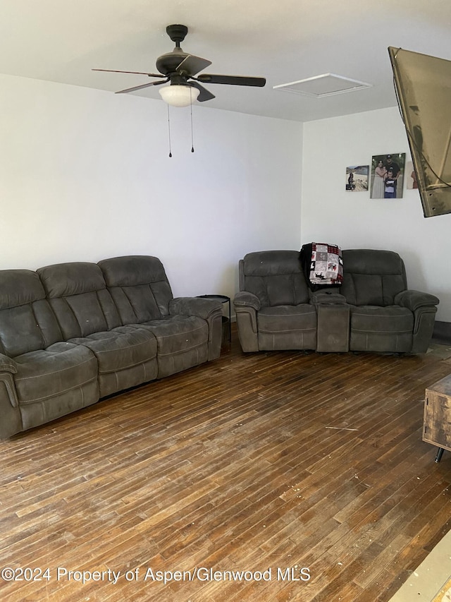 living room featuring ceiling fan and dark hardwood / wood-style floors