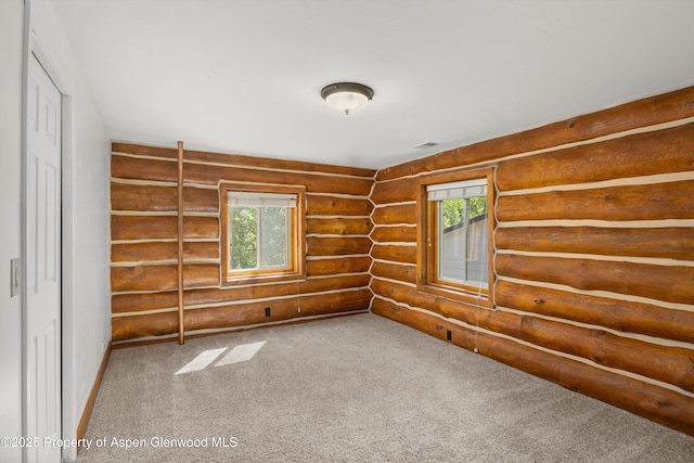 1116 Walz Ave, Glenwood Springs, CO 81601 - spare room featuring log walls and carpet