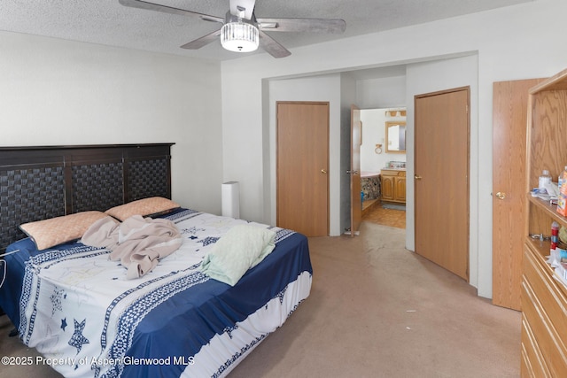 bedroom with ceiling fan, a closet, carpet, and a textured ceiling