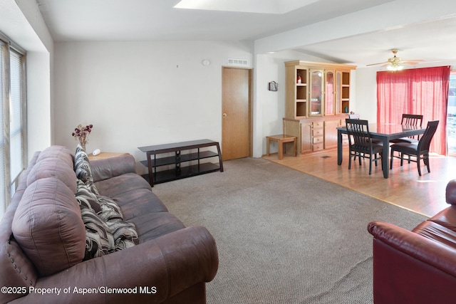 carpeted living room featuring ceiling fan