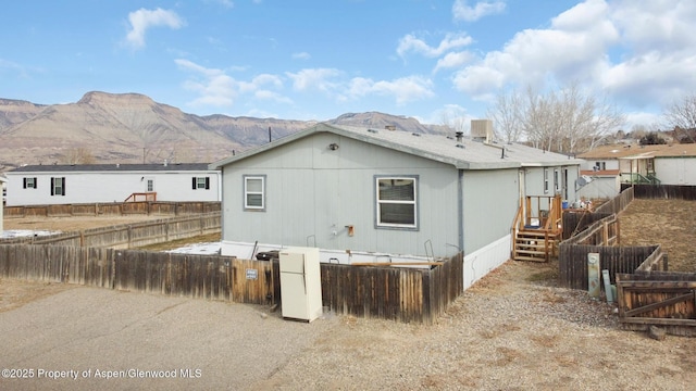 rear view of house featuring a mountain view