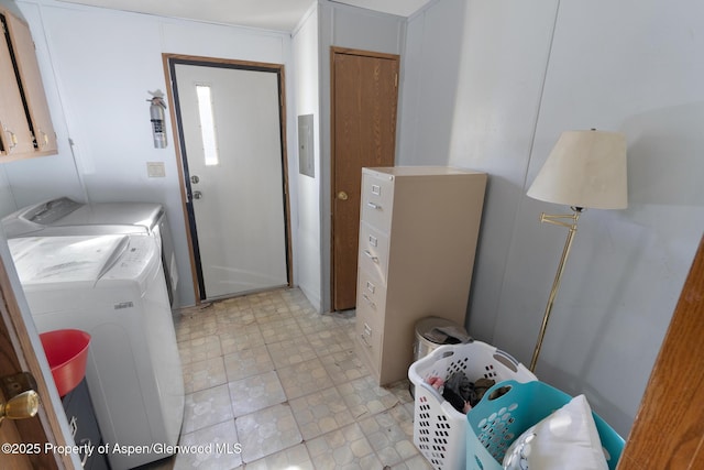 washroom featuring cabinets and washer and clothes dryer