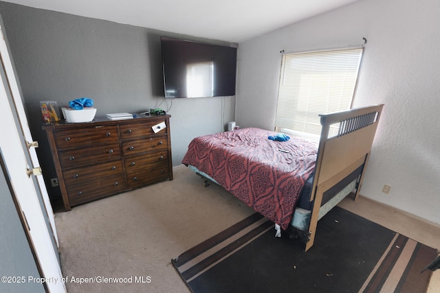 bedroom featuring vaulted ceiling and light colored carpet