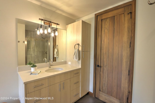 bathroom featuring vanity and a shower with shower door