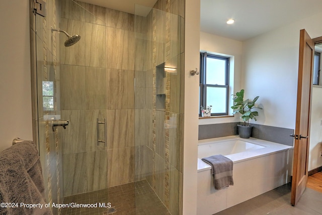 bathroom with shower with separate bathtub