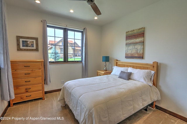 bedroom featuring light colored carpet and ceiling fan