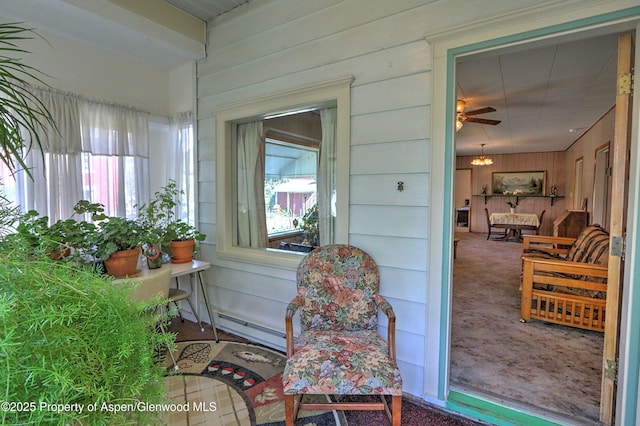 sunroom / solarium featuring baseboard heating and a healthy amount of sunlight