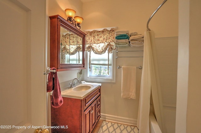 bathroom featuring shower / bathtub combination with curtain and vanity