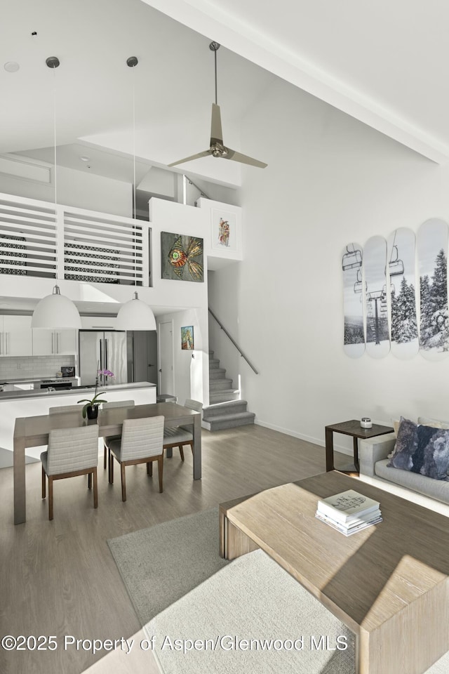 living room featuring hardwood / wood-style flooring and high vaulted ceiling