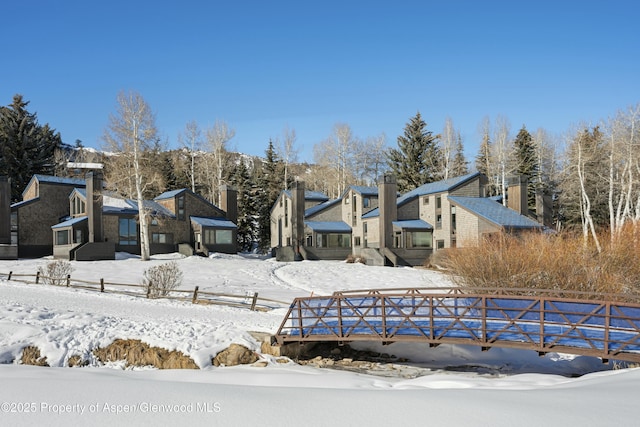 view of snow covered rear of property