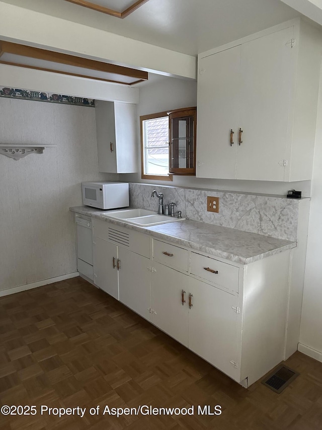 890 Breeze St, Craig, CO 81625 - kitchen featuring white appliances, light countertops, white cabinetry, and decorative backsplash