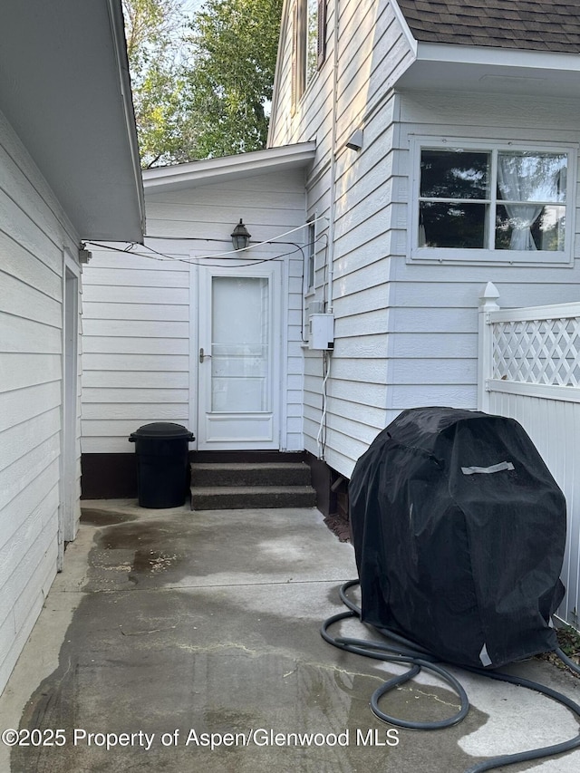 890 Breeze St, Craig, CO 81625 - doorway to property featuring a shingled roof and a patio