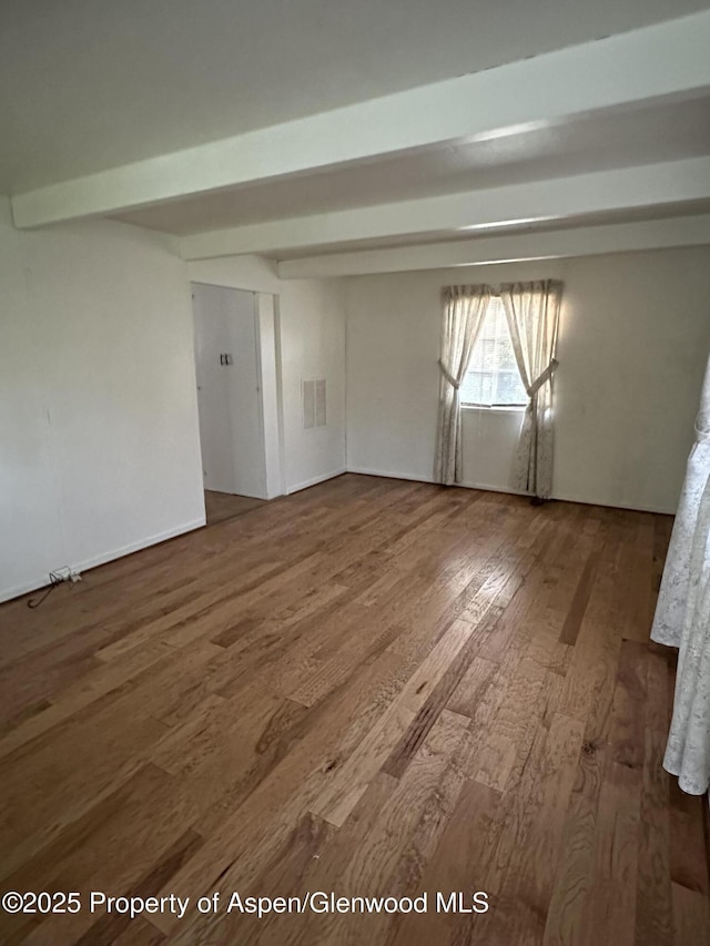 890 Breeze St, Craig, CO 81625 - empty room with wood finished floors and beamed ceiling
