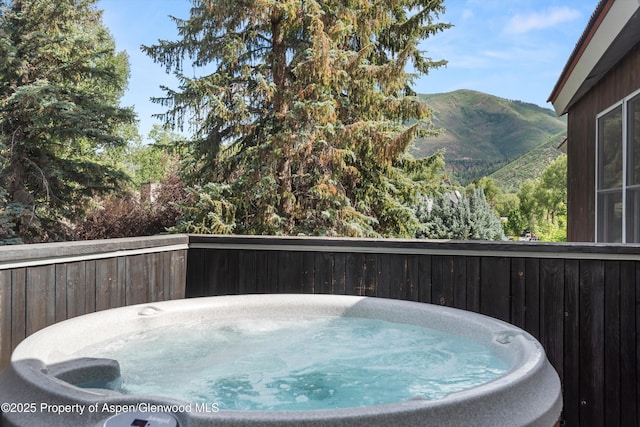 939 E Cooper Ave, Aspen, CO 81611 - view of swimming pool featuring a hot tub and a mountain view