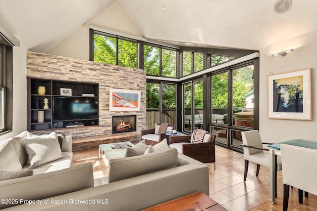 939 E Cooper Ave, Aspen, CO 81611 - tiled living area with a stone fireplace and high vaulted ceiling