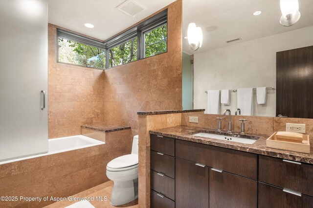 939 E Cooper Ave, Aspen, CO 81611 - full bath with healthy amount of natural light, vanity, and tile walls