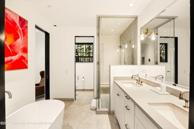 full bathroom featuring tile patterned flooring, vanity, separate shower and tub, and toilet