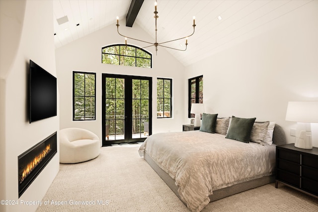 bedroom with beam ceiling, french doors, an inviting chandelier, high vaulted ceiling, and access to outside