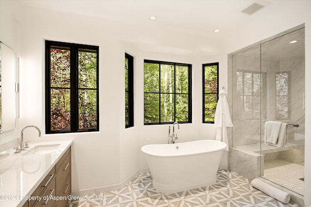 bathroom with vanity, tile patterned floors, and independent shower and bath