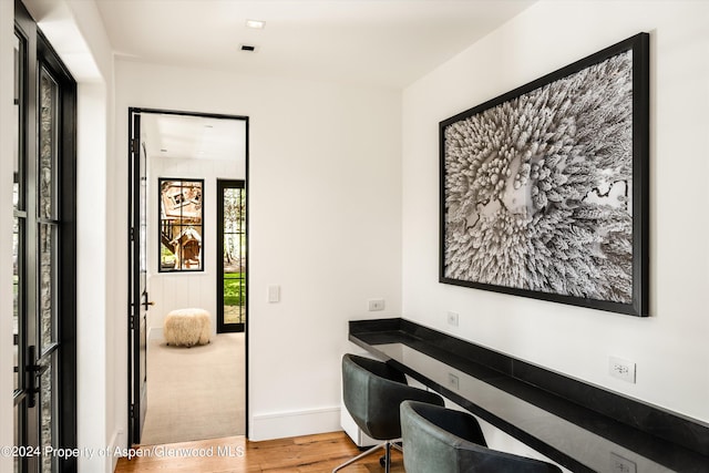 home office with hardwood / wood-style floors