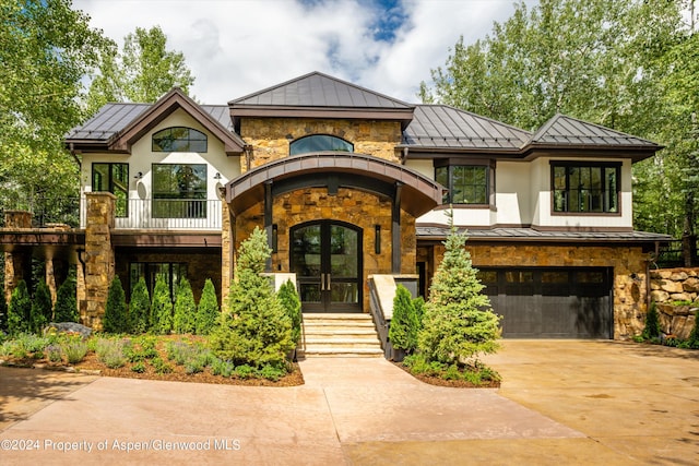 view of front of house with french doors and a garage