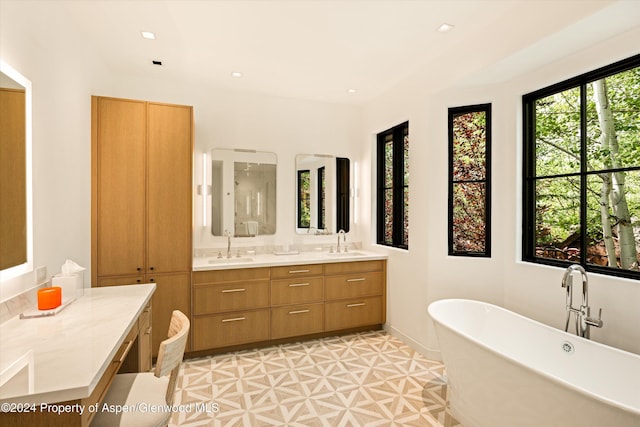 bathroom with vanity, tile patterned floors, and a bathing tub