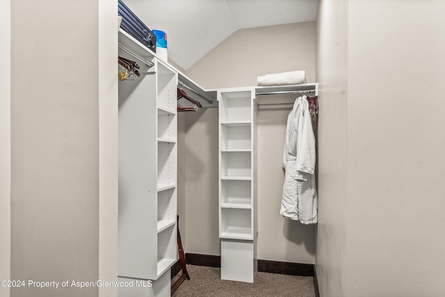 walk in closet featuring carpet floors and lofted ceiling