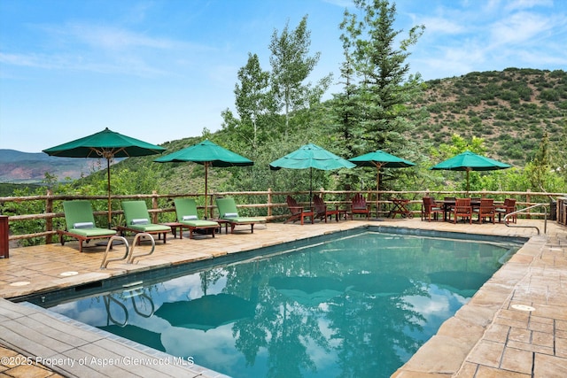 477 Aspen Oak Dr, Aspen, CO 81611 - view of swimming pool featuring a mountain view and outdoor dining space