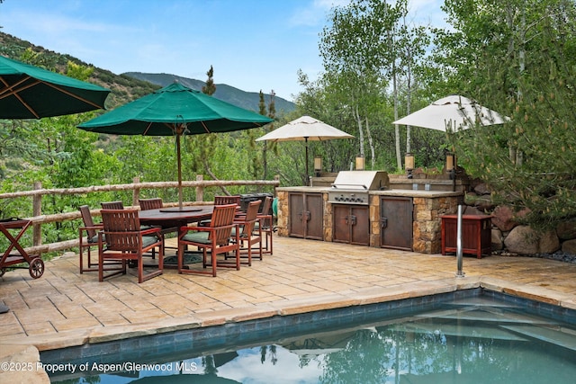 477 Aspen Oak Dr, Aspen, CO 81611 - swimming pool with area for grilling, a patio, outdoor dining space, and a mountain view