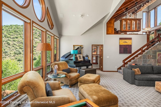 477 Aspen Oak Dr, Aspen, CO 81611 - carpeted living room with high vaulted ceiling, healthy amount of natural light, and stairway