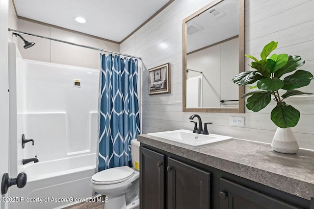 full bathroom featuring shower / tub combo, visible vents, toilet, vanity, and wood walls