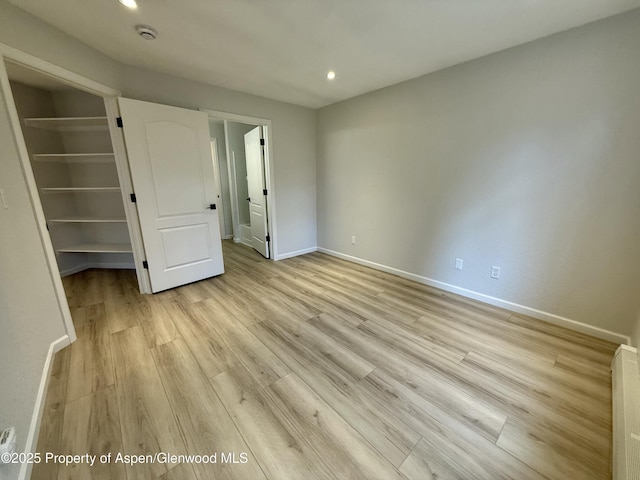 3102 Elk Ln, Basalt, CO 81621 - unfurnished bedroom featuring baseboards, a spacious closet, and light wood-style flooring