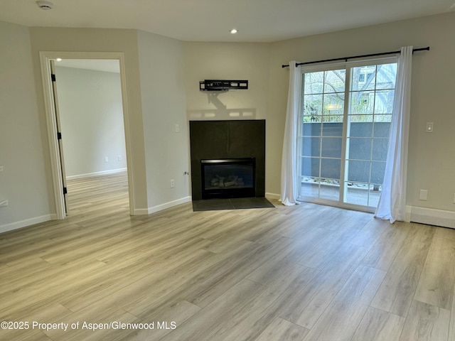 3102 Elk Ln, Basalt, CO 81621 - unfurnished living room with light wood-style floors, a fireplace with flush hearth, baseboards, and recessed lighting