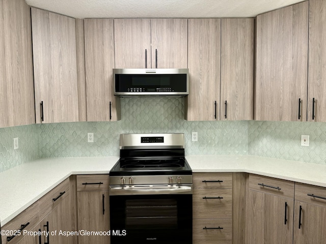 3102 Elk Ln, Basalt, CO 81621 - kitchen featuring light countertops, appliances with stainless steel finishes, light brown cabinetry, and tasteful backsplash