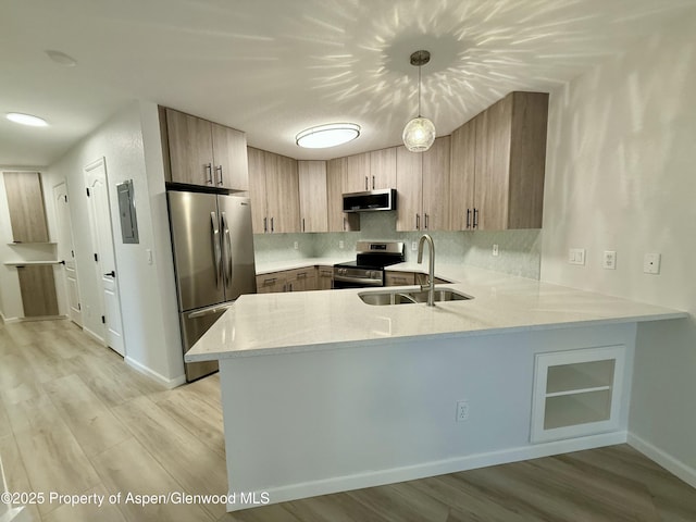 3102 Elk Ln, Basalt, CO 81621 - kitchen featuring a peninsula, light stone countertops, tasteful backsplash, a sink, and stainless steel appliances