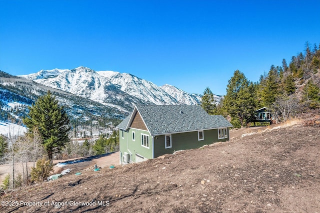 787 Serpentine Trl, Marble, CO 81623 - view of side of property with a mountain view, a garage, and driveway