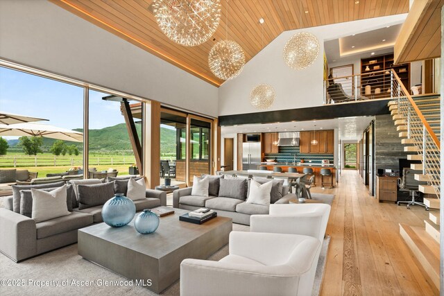 425 Aspen Valley Ranch Rd, Woody Creek, CO 81656 - living area with wood ceiling, high vaulted ceiling, a mountain view, light wood-style floors, and a chandelier