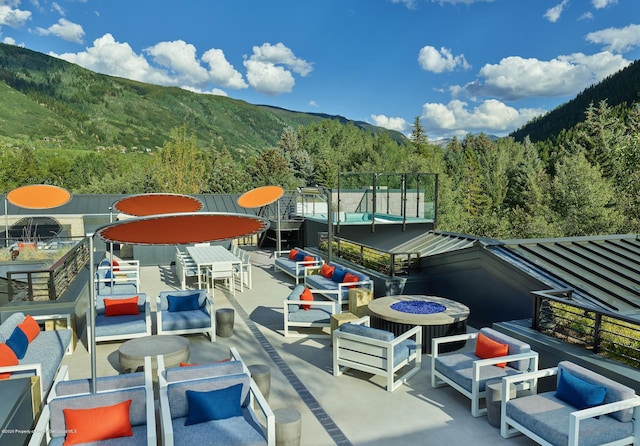 view of patio / terrace featuring a mountain view, an outdoor living space, and cooling unit