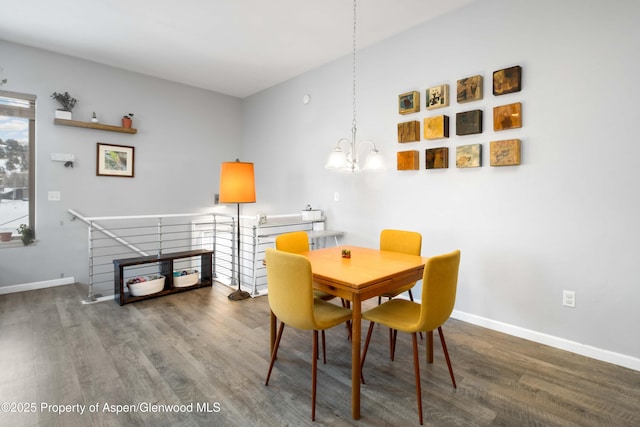 dining area featuring wood-type flooring and an inviting chandelier