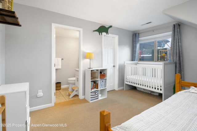 carpeted bedroom with connected bathroom