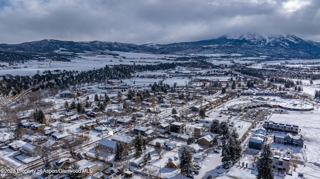 snowy aerial view featuring a mountain view