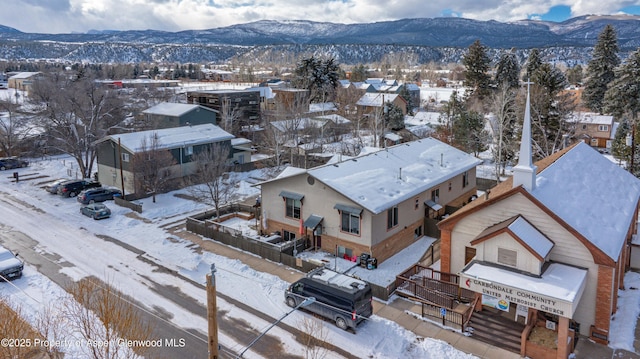 snowy aerial view featuring a mountain view