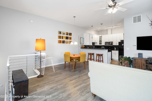 living room featuring hardwood / wood-style floors and ceiling fan