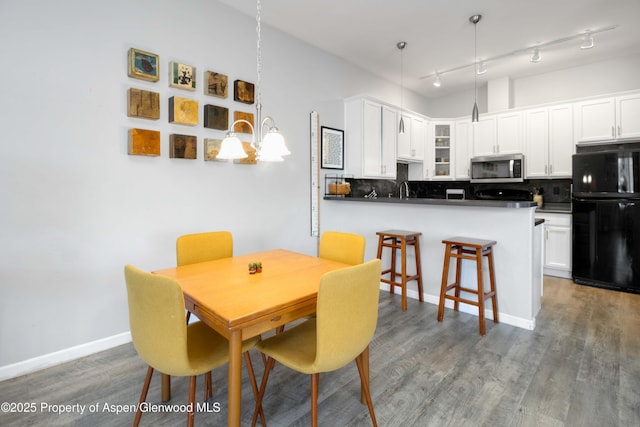 dining area with dark wood-type flooring