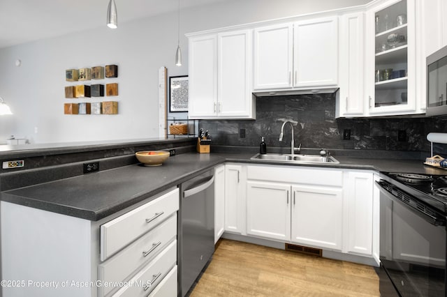 kitchen featuring stainless steel dishwasher, decorative light fixtures, white cabinets, and sink