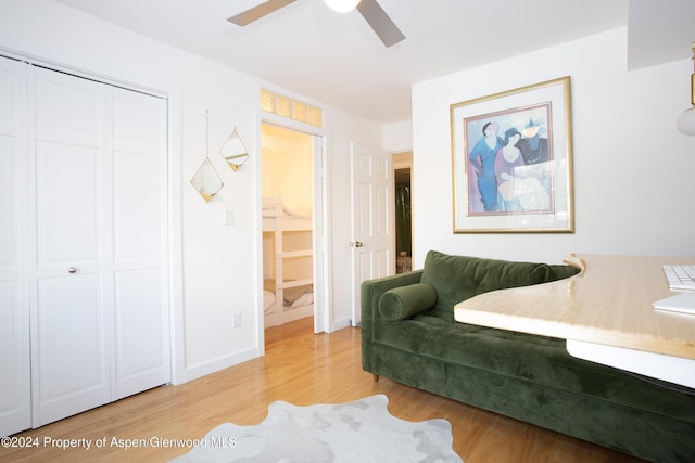 sitting room with light wood-type flooring and ceiling fan