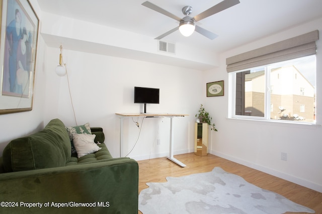 living area featuring ceiling fan and light hardwood / wood-style flooring