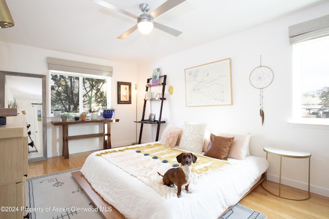 bedroom with ceiling fan and light hardwood / wood-style flooring