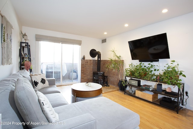 living room featuring hardwood / wood-style floors and a wood stove