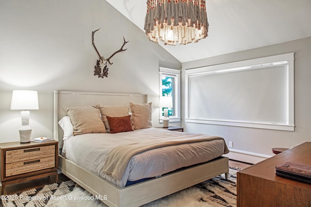 52 Harleston Grn Unit 38, Snowmass Village, CO 81615 - bedroom with wood finished floors, a chandelier, baseboard heating, and lofted ceiling